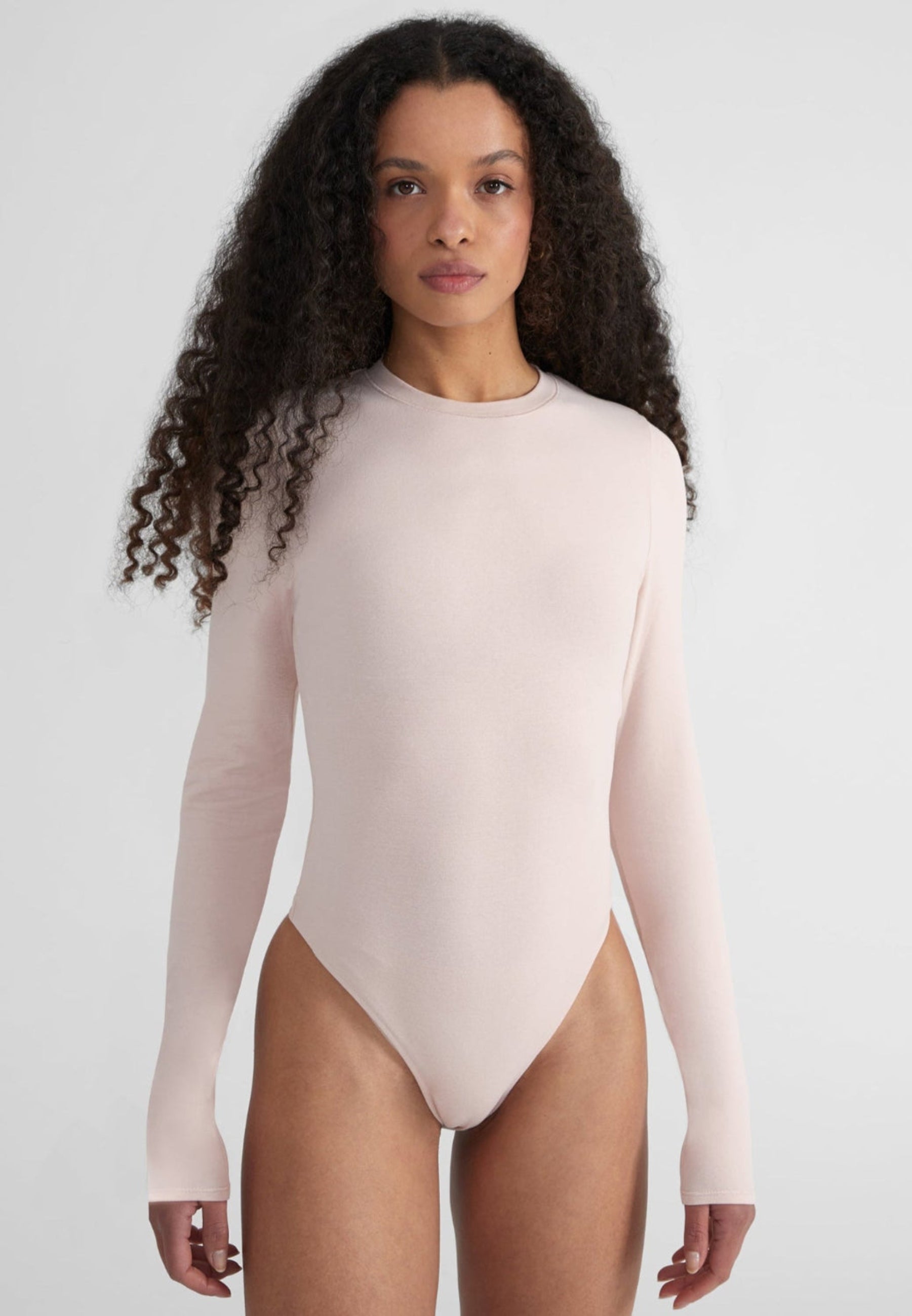 Woman wearing Fitted Longsleeve Bodysuit - baby pink